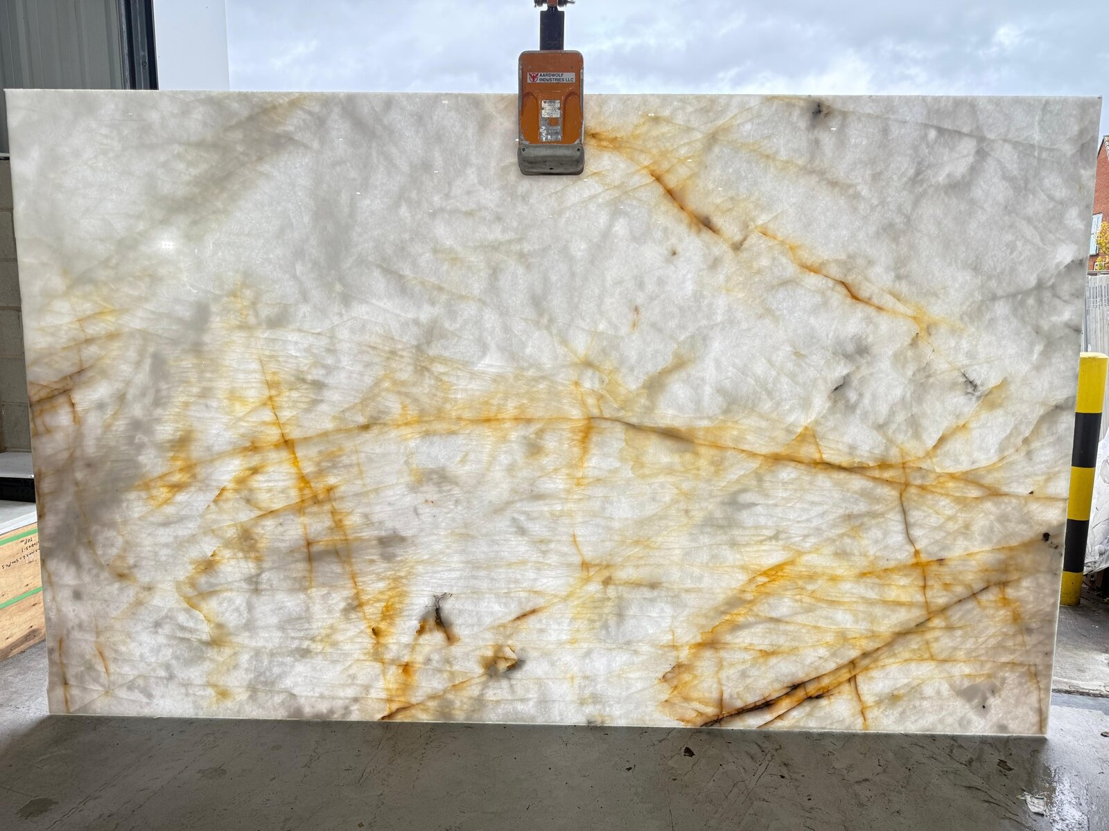 Cristallo Quartzite slab held against daylight, showing its natural translucency